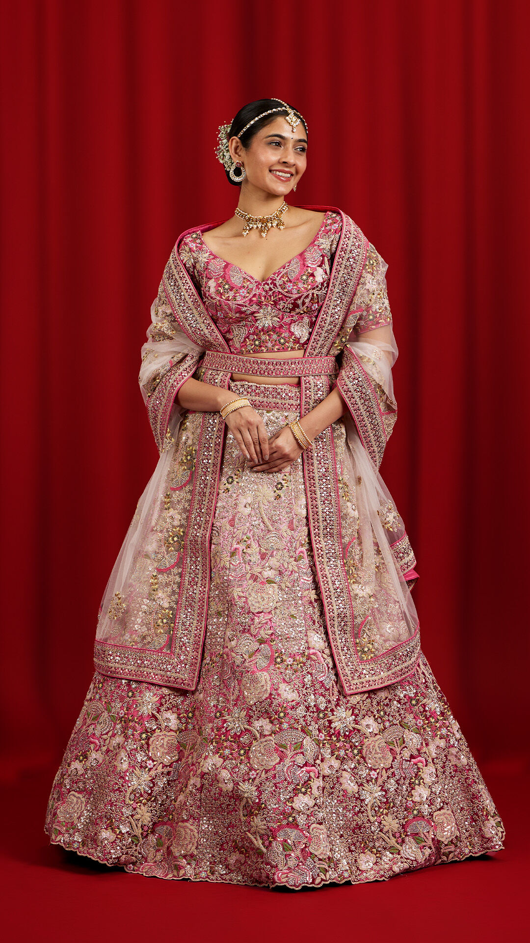 Chic pink lehenga paired with a matching pink dupatta, a fashionable floral ensemble for weddings.